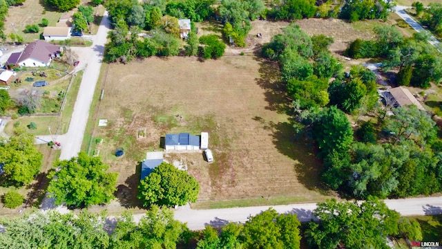 birds eye view of property with a rural view