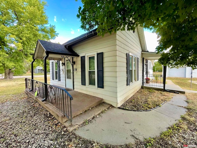 view of property exterior featuring a porch and a garage