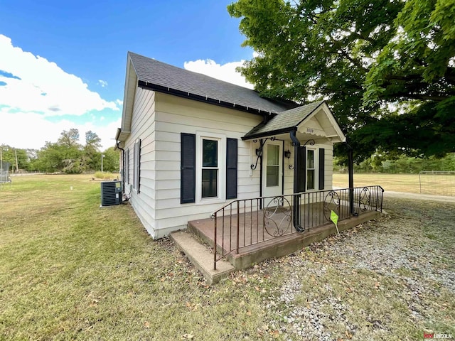 3800 SW 16th St, Lincoln, NE 68522 - bungalow featuring a front yard, central AC unit, and roof with shingles