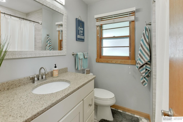 bathroom featuring walk in shower, vanity, and toilet