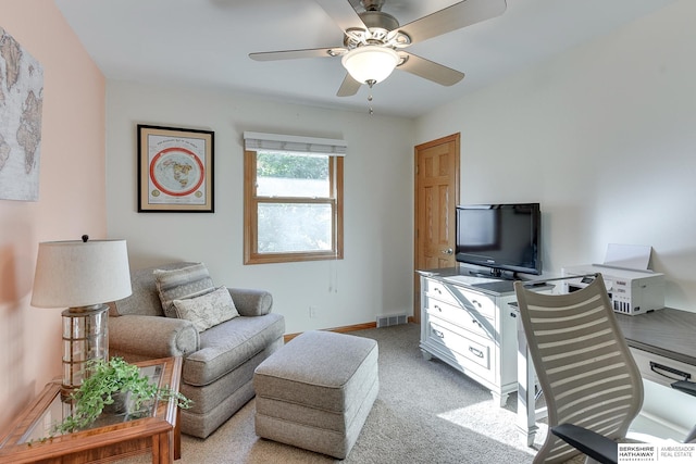 carpeted home office featuring ceiling fan