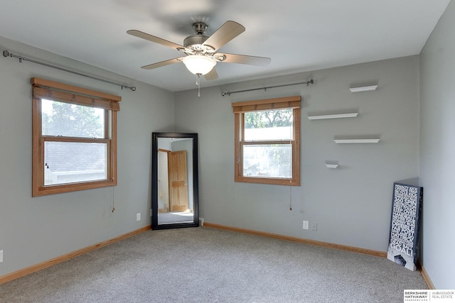 unfurnished room featuring ceiling fan and carpet floors