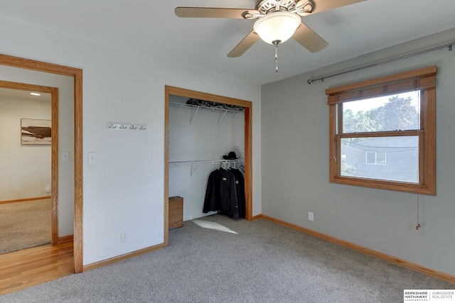 unfurnished bedroom featuring ceiling fan, light colored carpet, and a closet