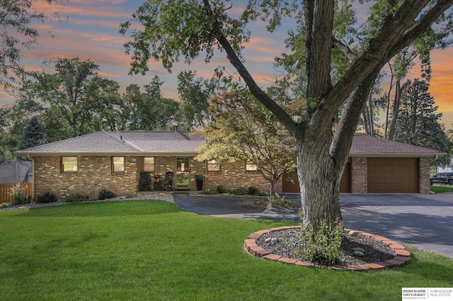 view of front of property with a yard and a garage