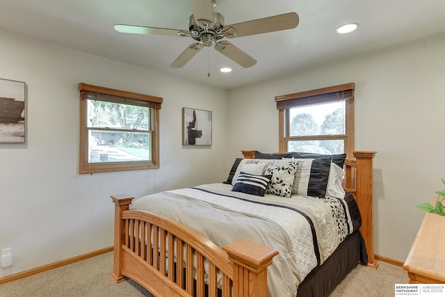 bedroom with ceiling fan and light colored carpet