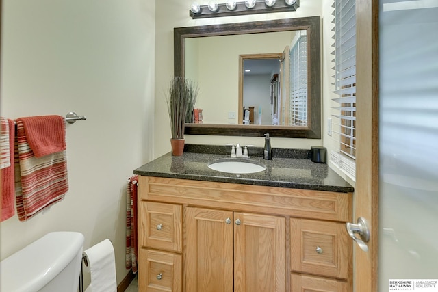 bathroom featuring vanity and toilet