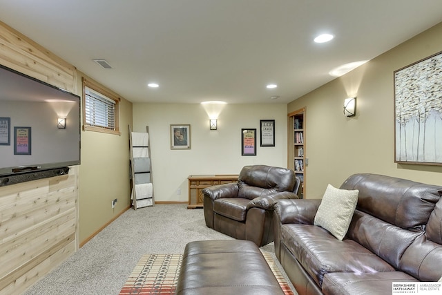 carpeted living room featuring wood walls