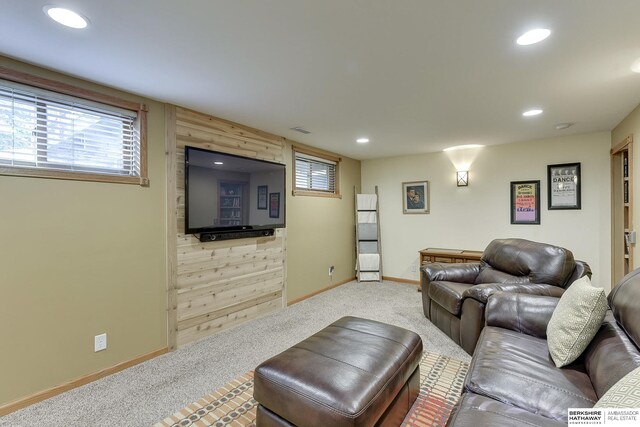 carpeted living room featuring wood walls