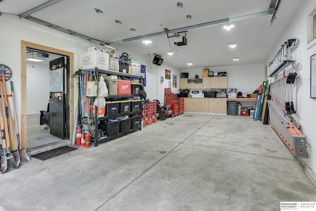 garage with a garage door opener and a workshop area