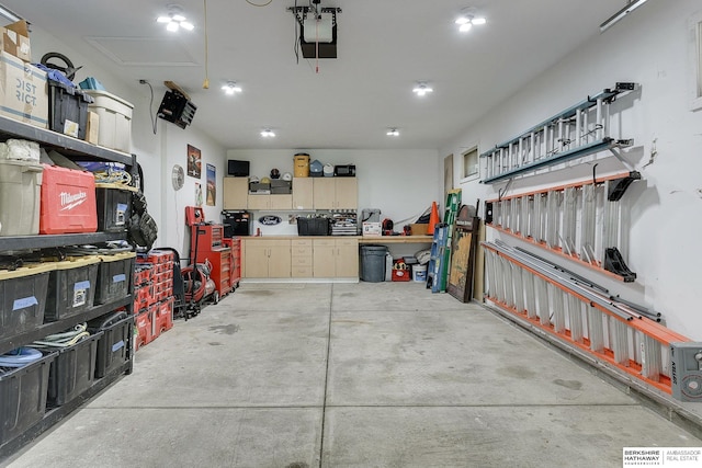 garage with a garage door opener and a workshop area