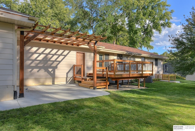 back of property featuring a pergola, a wooden deck, a yard, and a patio area