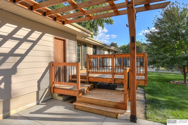 wooden terrace featuring a pergola and a yard