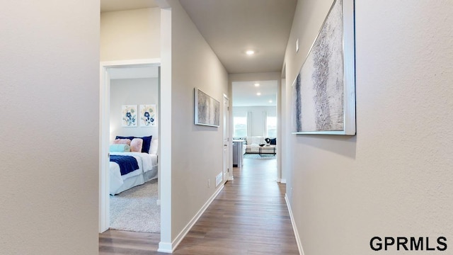 hallway with hardwood / wood-style flooring