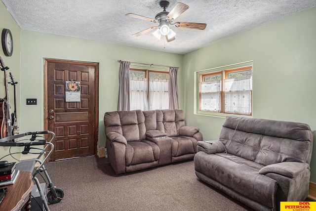 living room featuring ceiling fan, plenty of natural light, carpet floors, and a textured ceiling