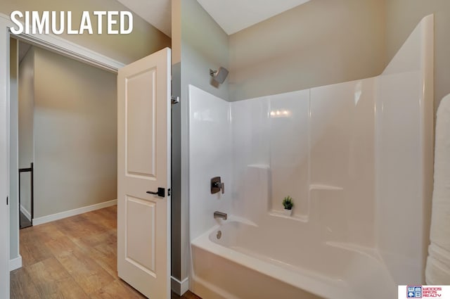 bathroom featuring wood-type flooring and  shower combination