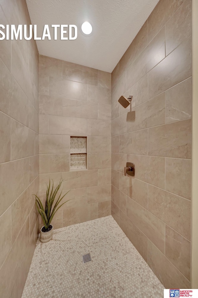 bathroom with tiled shower