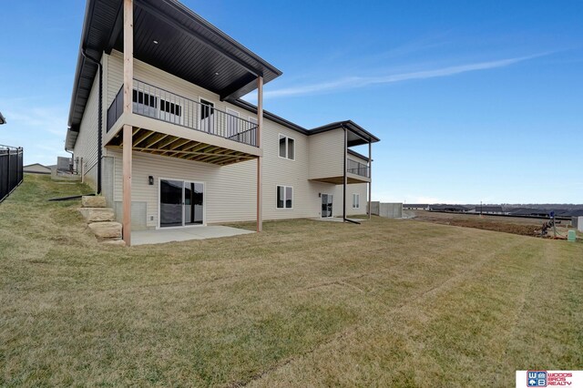 back of house with a yard and a patio area