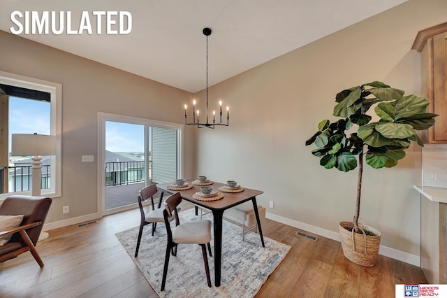 dining room featuring a notable chandelier and light wood-type flooring