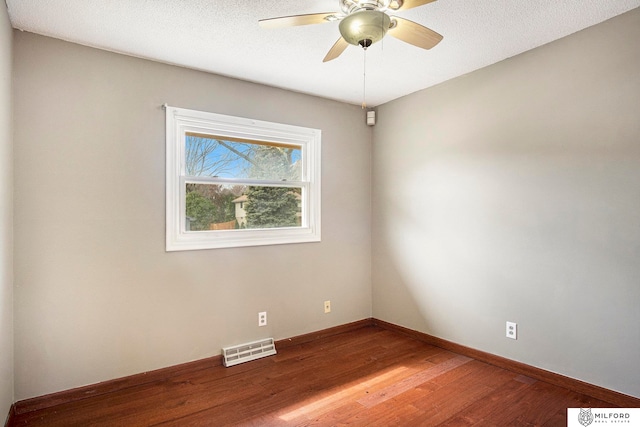 unfurnished room with a textured ceiling, ceiling fan, and hardwood / wood-style flooring