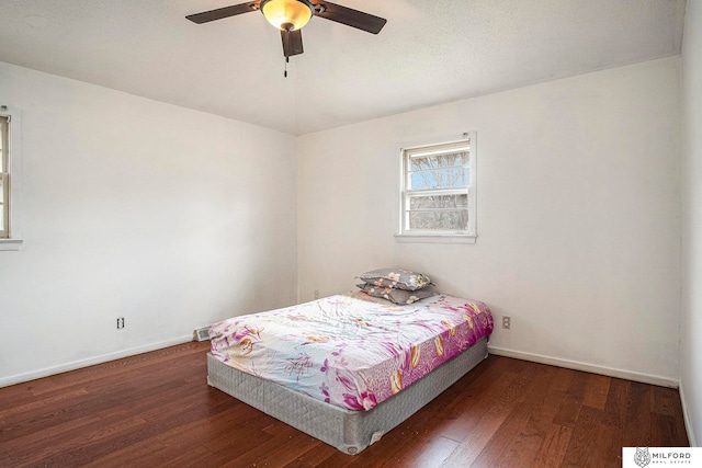 bedroom with ceiling fan and dark hardwood / wood-style flooring