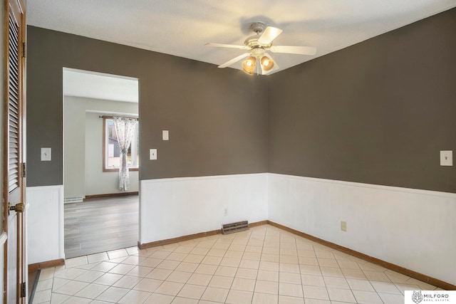 unfurnished room with light hardwood / wood-style flooring, ceiling fan, and a textured ceiling