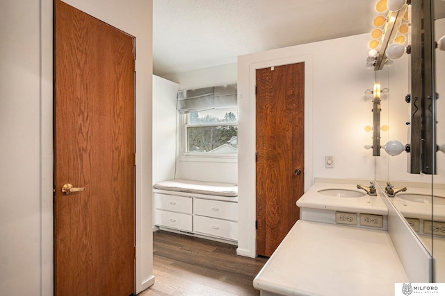 bathroom featuring a textured ceiling, hardwood / wood-style flooring, and vanity