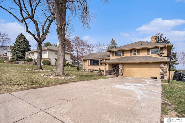 view of front of property featuring a garage and a front lawn