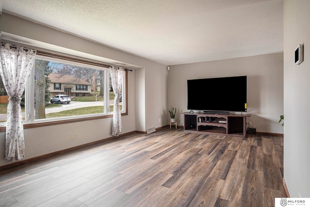 living room featuring a textured ceiling and hardwood / wood-style floors