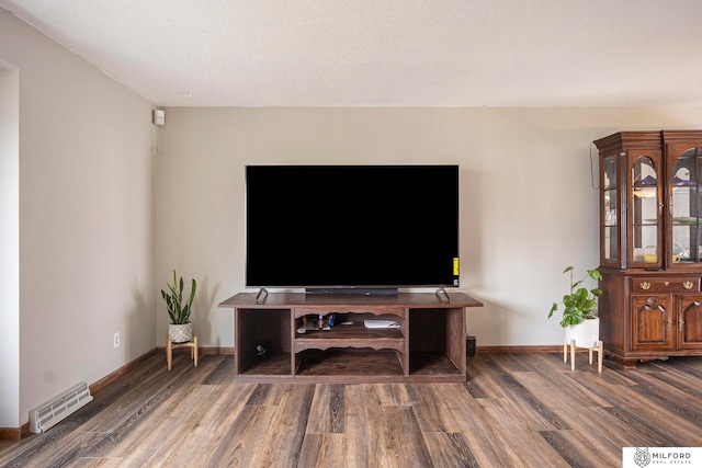 living room featuring a textured ceiling and dark wood-type flooring