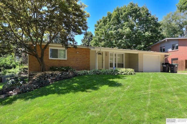 ranch-style home with a front yard and a garage