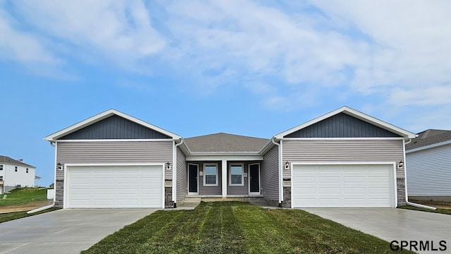 view of front of house with a garage and a front yard