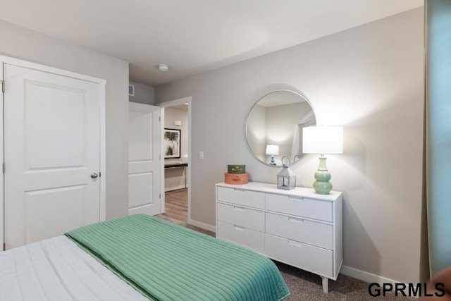 bedroom with dark colored carpet