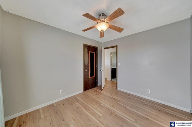 spare room with ceiling fan and light hardwood / wood-style floors