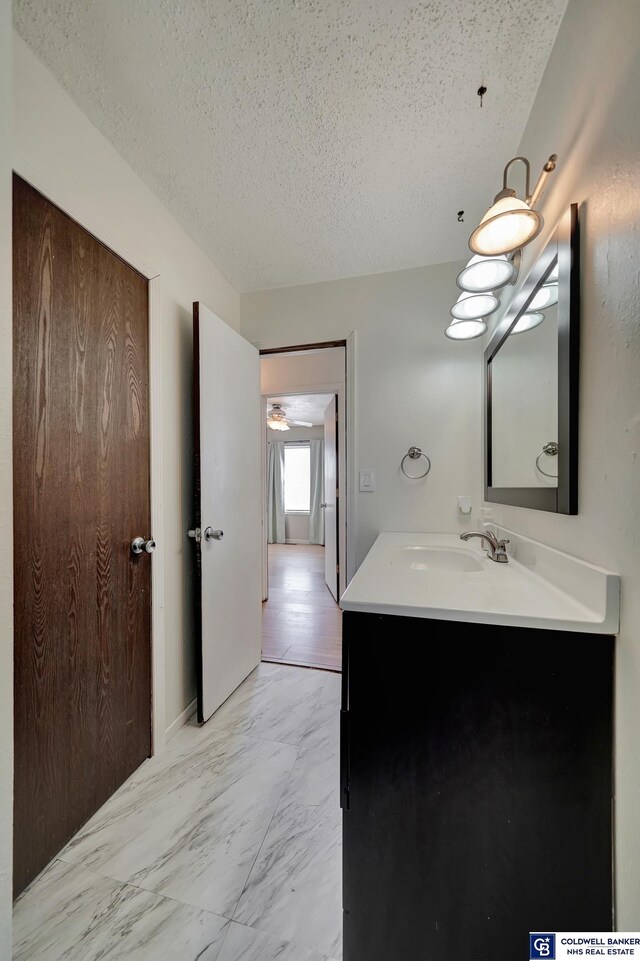 bathroom with a textured ceiling and vanity