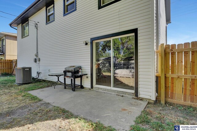 rear view of house featuring a patio and central AC