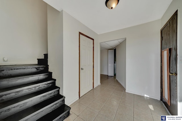 staircase with tile patterned floors