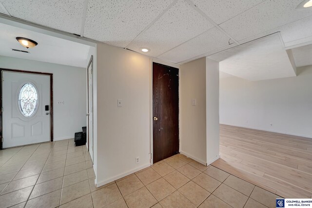 foyer with a drop ceiling and light hardwood / wood-style flooring