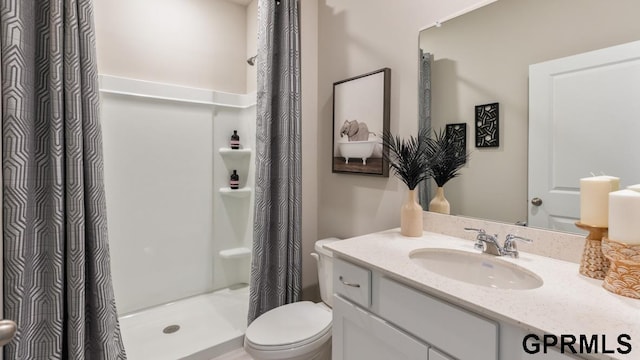 bathroom featuring a shower with curtain, vanity, and toilet