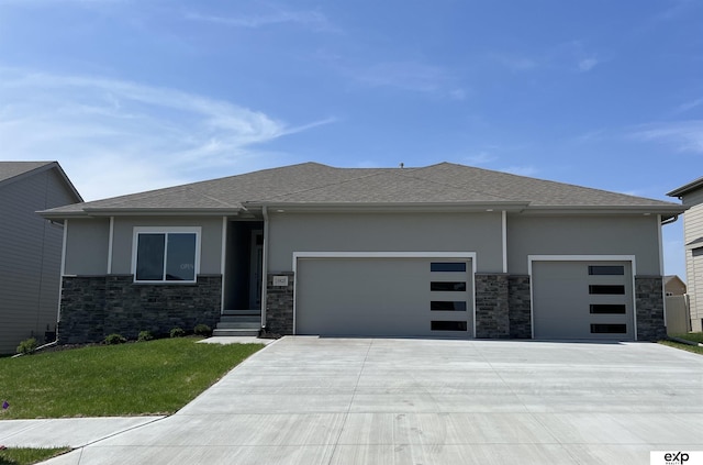 prairie-style home featuring stucco siding, concrete driveway, stone siding, and a garage