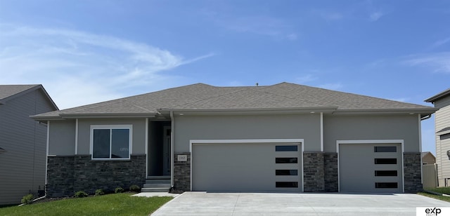 view of front of house featuring stone siding, roof with shingles, stucco siding, an attached garage, and driveway