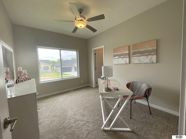 home office with ceiling fan, light carpet, and baseboards