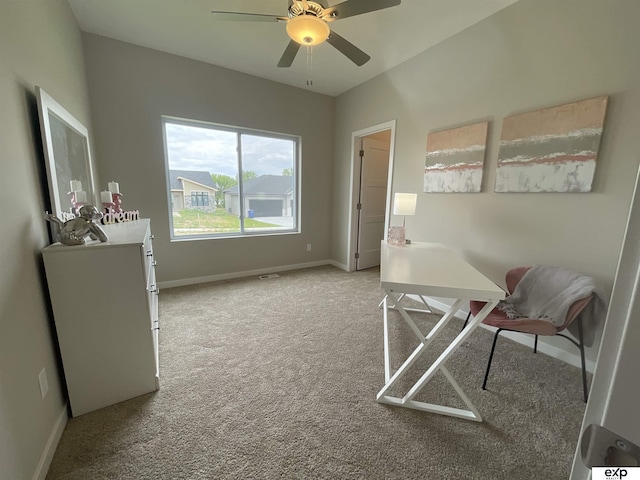home office featuring a ceiling fan, baseboards, and light carpet