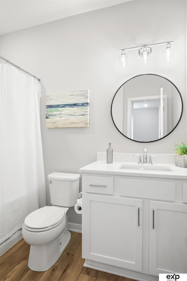 full bathroom with vanity, a shower with curtain, toilet, and wood finished floors