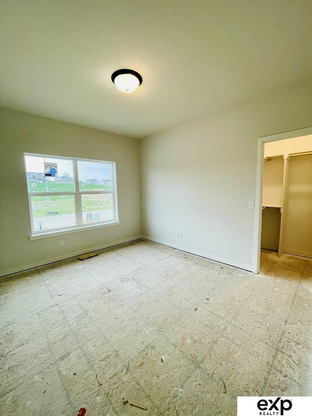 spare room featuring baseboards