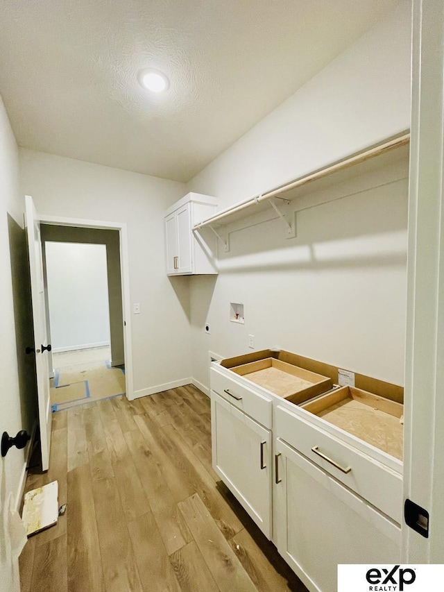 laundry room with baseboards, cabinet space, hookup for an electric dryer, light wood-style flooring, and washer hookup