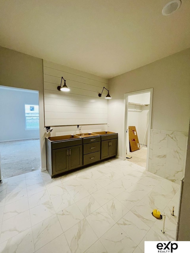 bathroom with vanity and marble finish floor