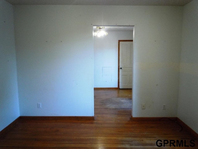 spare room with dark hardwood / wood-style flooring