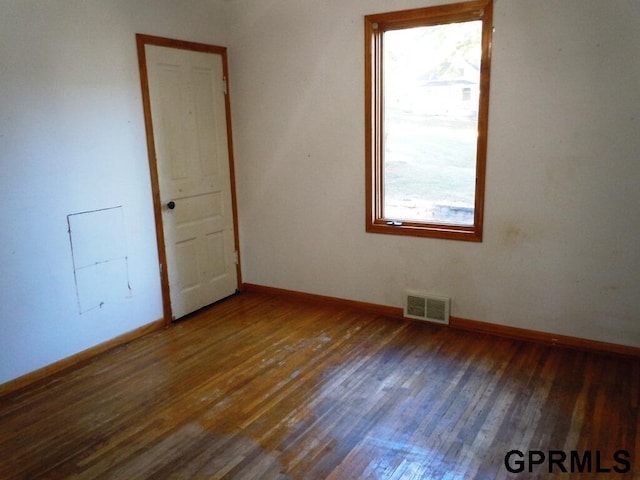 spare room featuring dark hardwood / wood-style floors