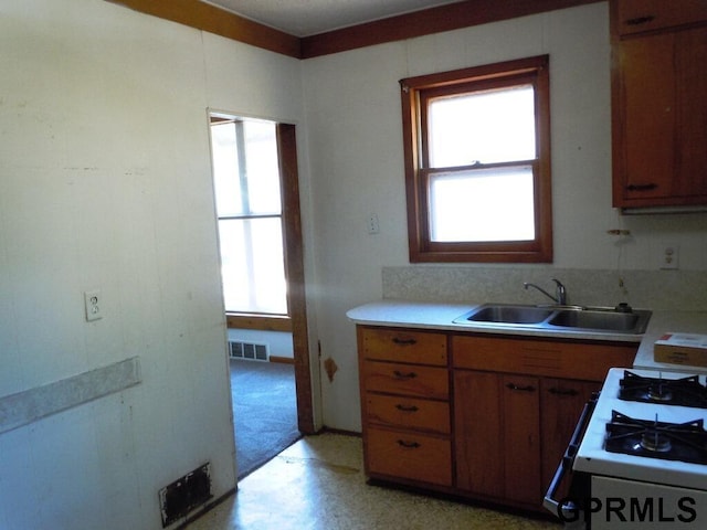 kitchen with white gas range and sink