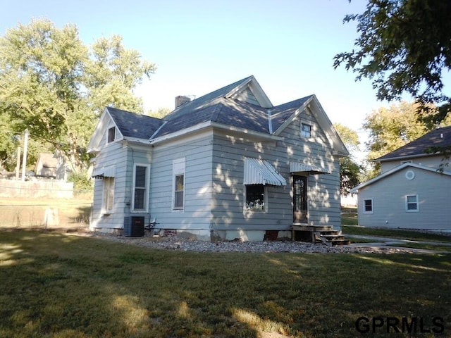 exterior space with a front lawn and central AC unit